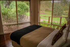 Awaken's second bedroom has a queen bed and a lovely view over a small garden courtyard